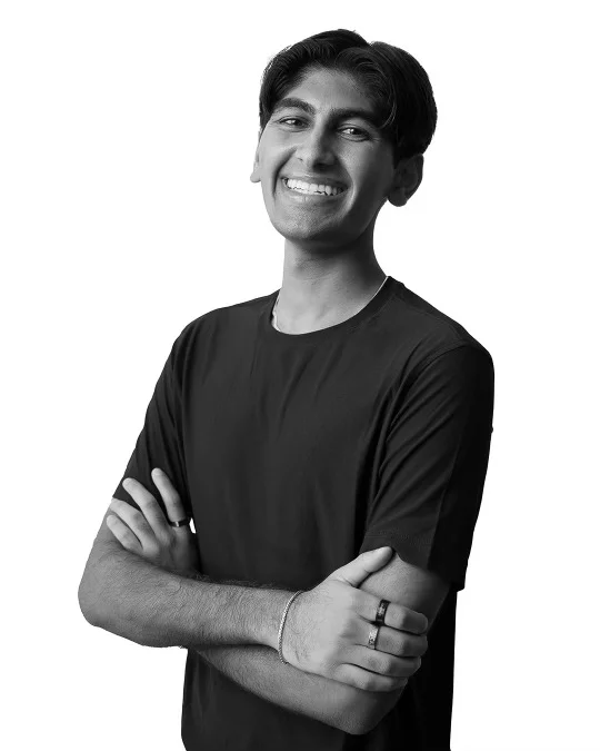 Nitin Chatlani smiling with his arms crossed